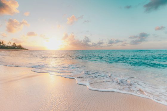 Sunset light across a quiet beach and open sea