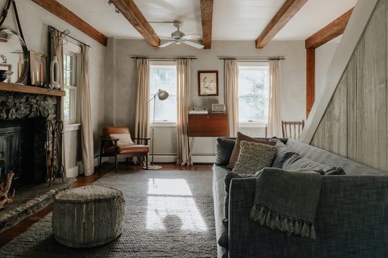 A sunlit living room with a soft sofa