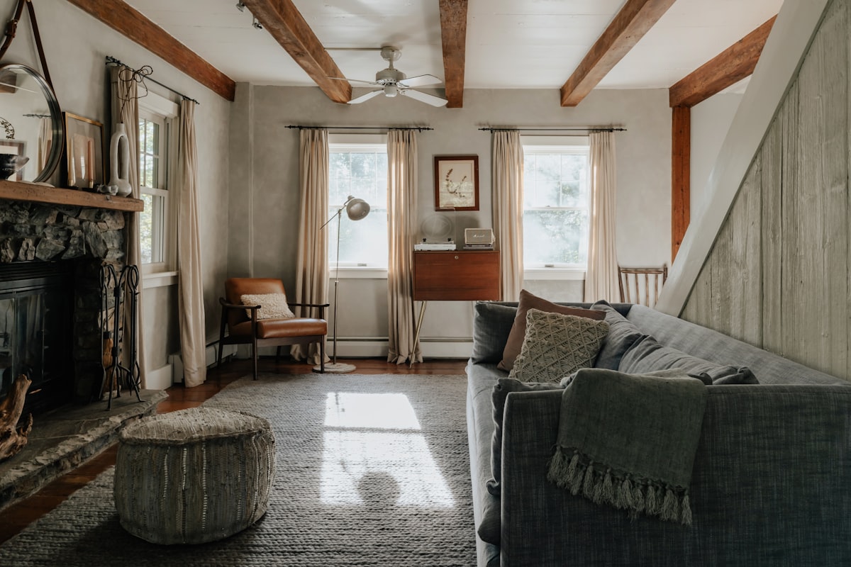 A sunlit living room with a soft sofa
